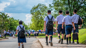 Children walking down the sidewalk