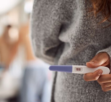 Woman holding pregnancy test